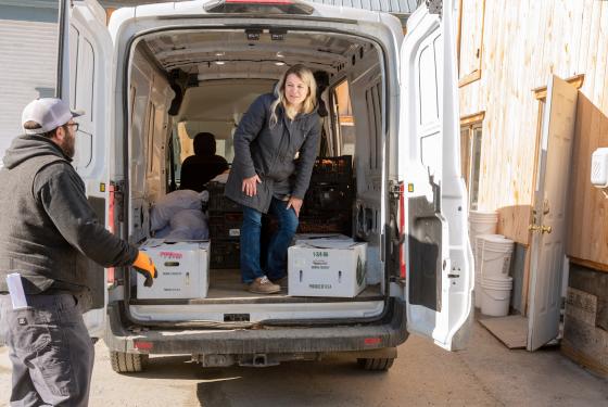 Roots Market Karin Bellemare unloads a truck.