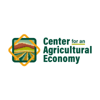 Center for an Agricultural Economy Logo. Crop rows in front of mountains